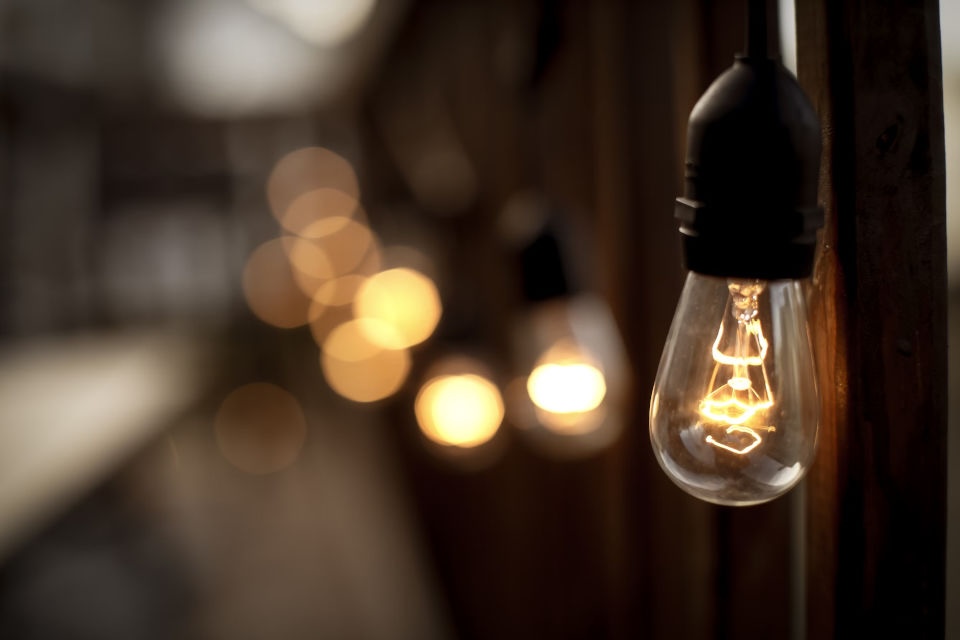 A light bulb glowing in the dark.
