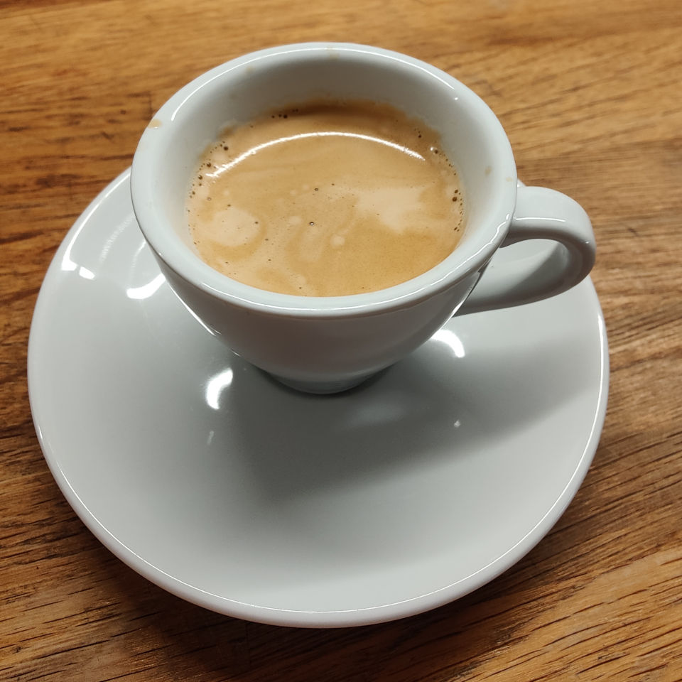 An espresso with good-looking crema in a white cup